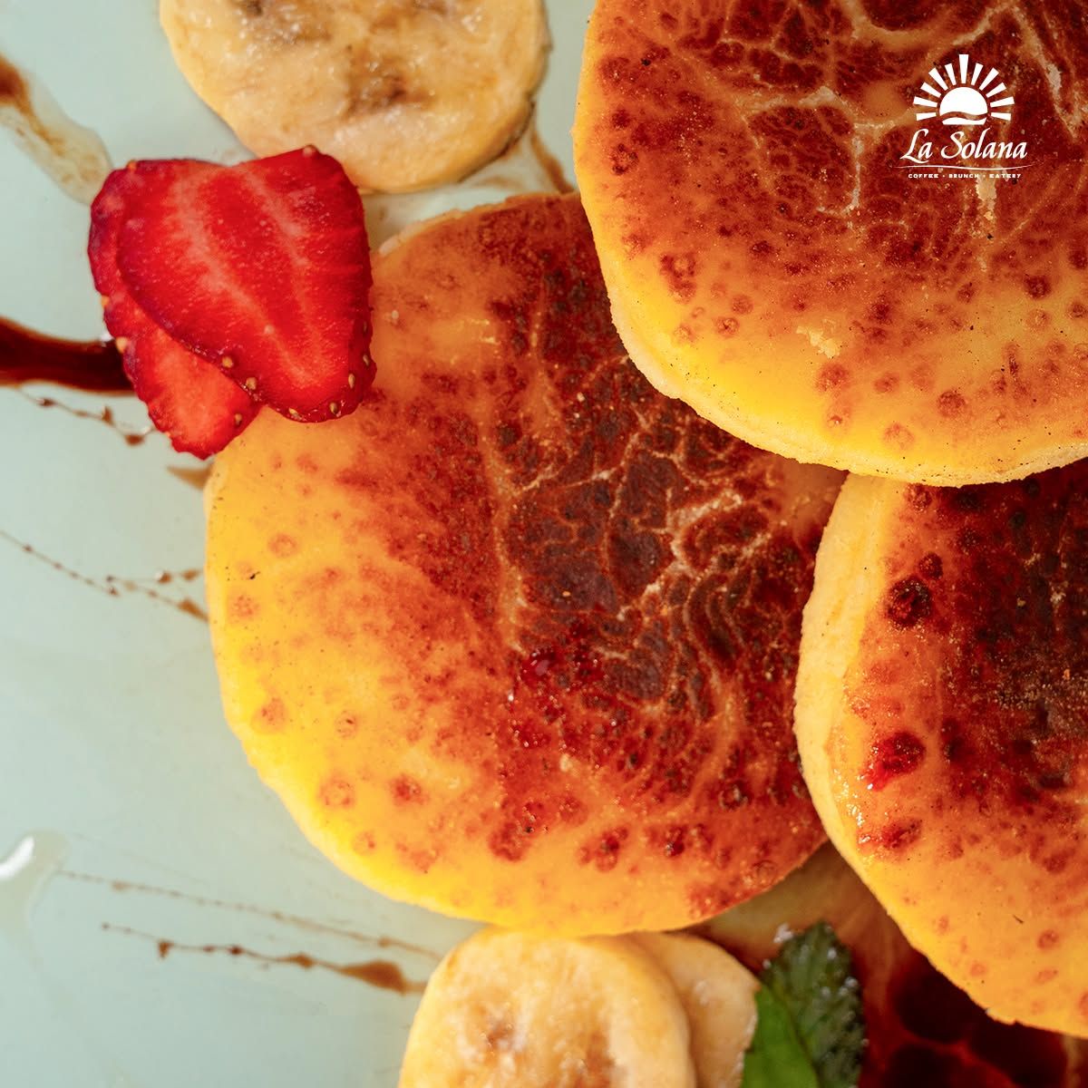 House-made syrniki cottage cheese pancakes with strawberry and banana