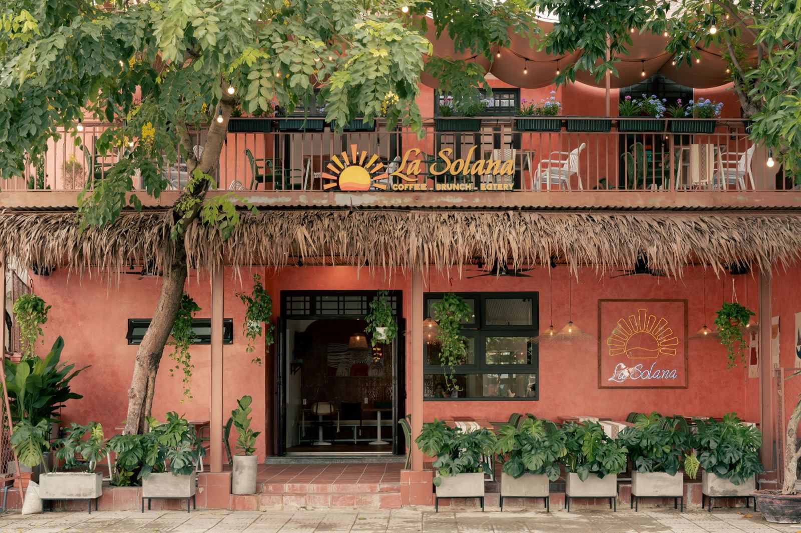 La Solana's terracotta façade with a thatched awning and monstera planters