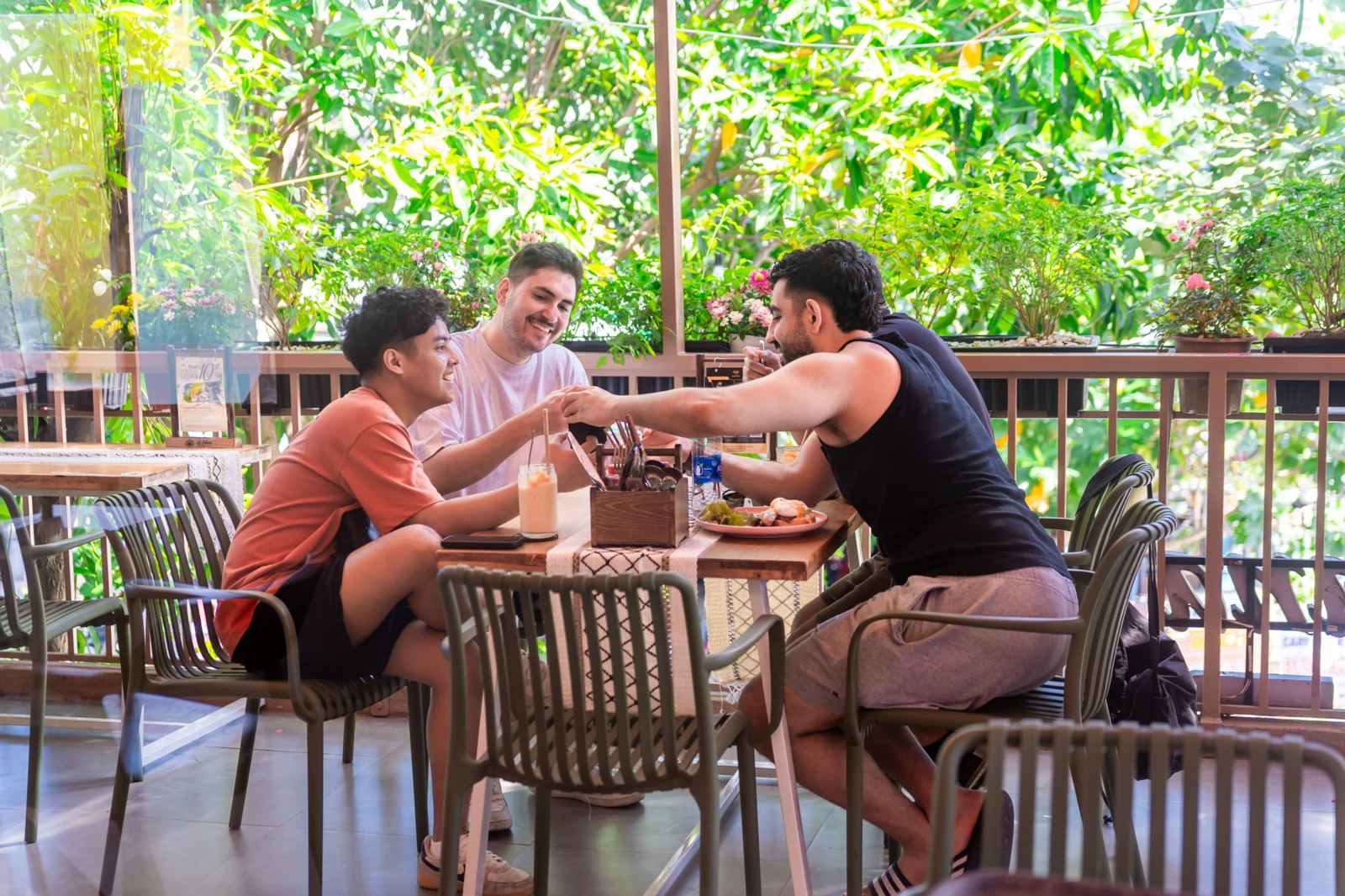 Friends laughing over brunch on the treetop terrace