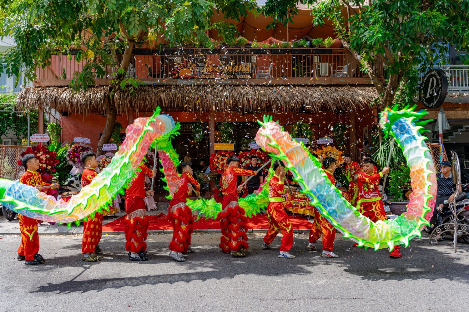 Dragon dance with confetti in front of La Solana on opening day
