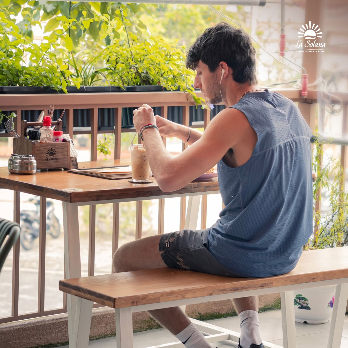 A guest having breakfast alone on the treetop terrace