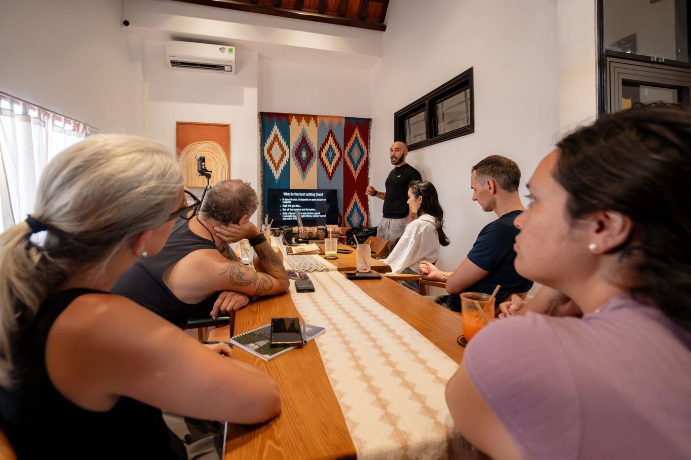 Participants around the long table at a photography workshop in the meeting room